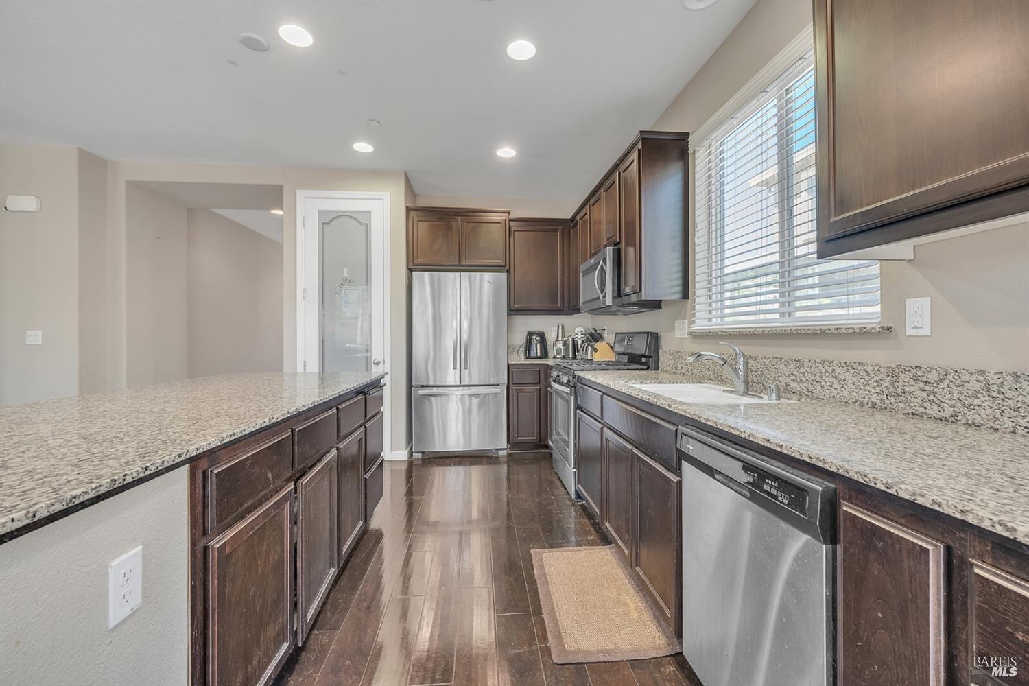 526 Epic Street Vacaville, CA 95688 - Photo 10 of 39 a kitchen with stainless steel appliances granite countertop a sink a stove a refrigerator and a oven