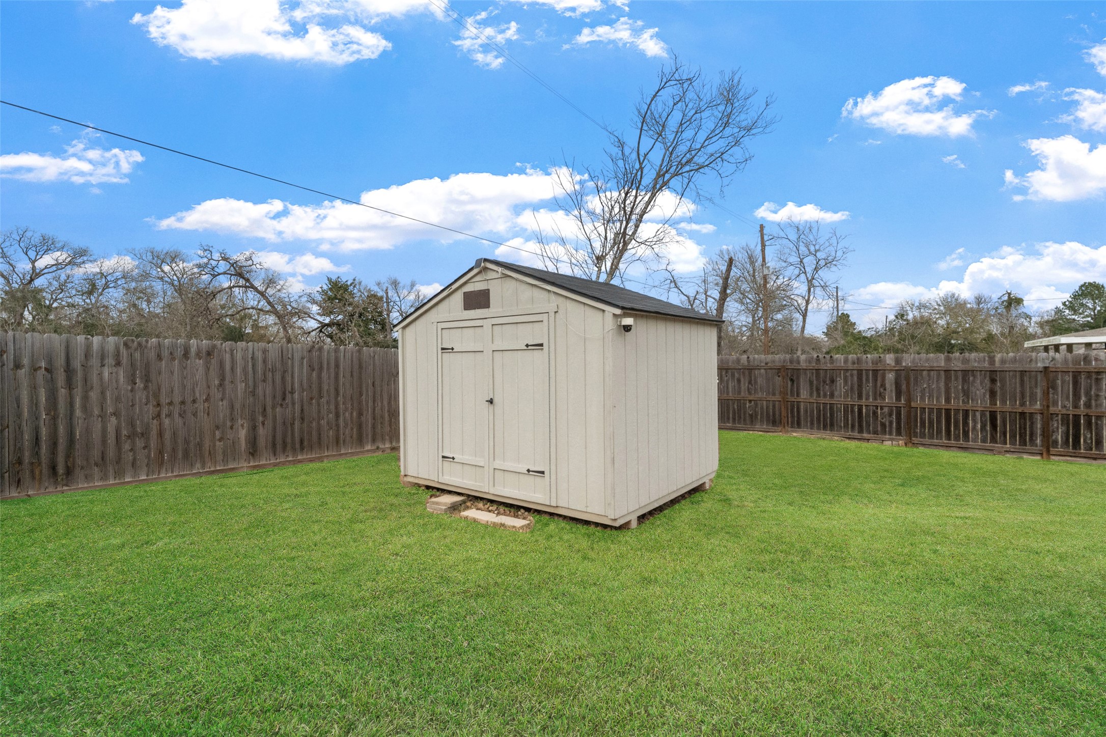 26431 Pin Oak Drive Hempstead, TX 77445 - Photo 23 of 32 Backyard storage shed provides extra space for tools, lawn equipment, and seasonal items. The fully fenced yard offers room to enjoy outdoor living. Lawn appearance has been digitally enhanced.