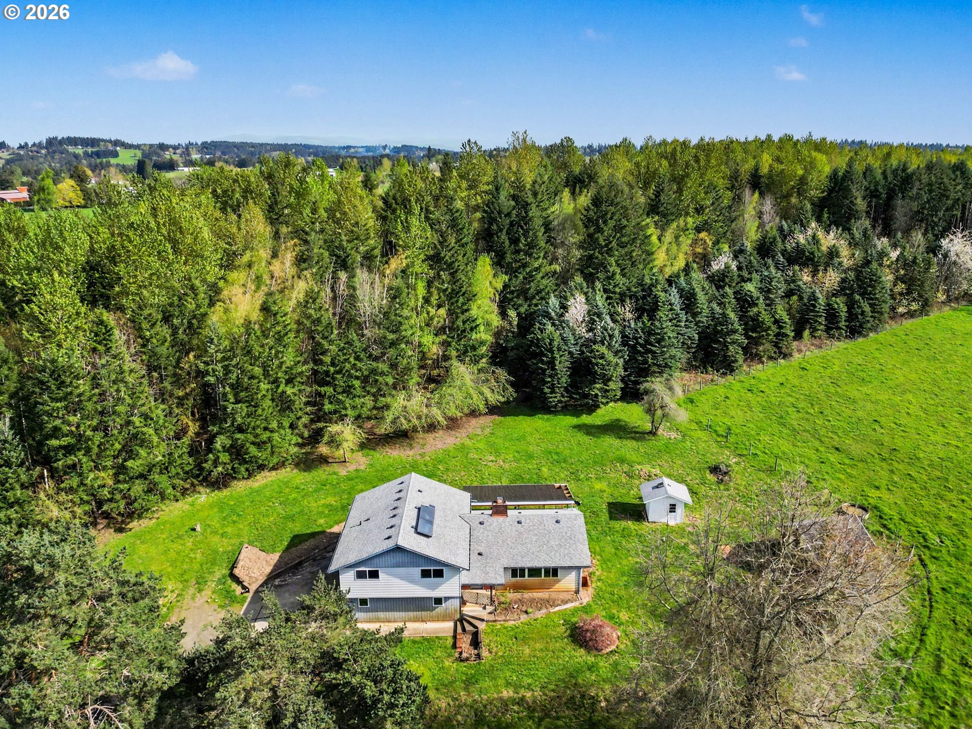 a aerial view of a house with yard