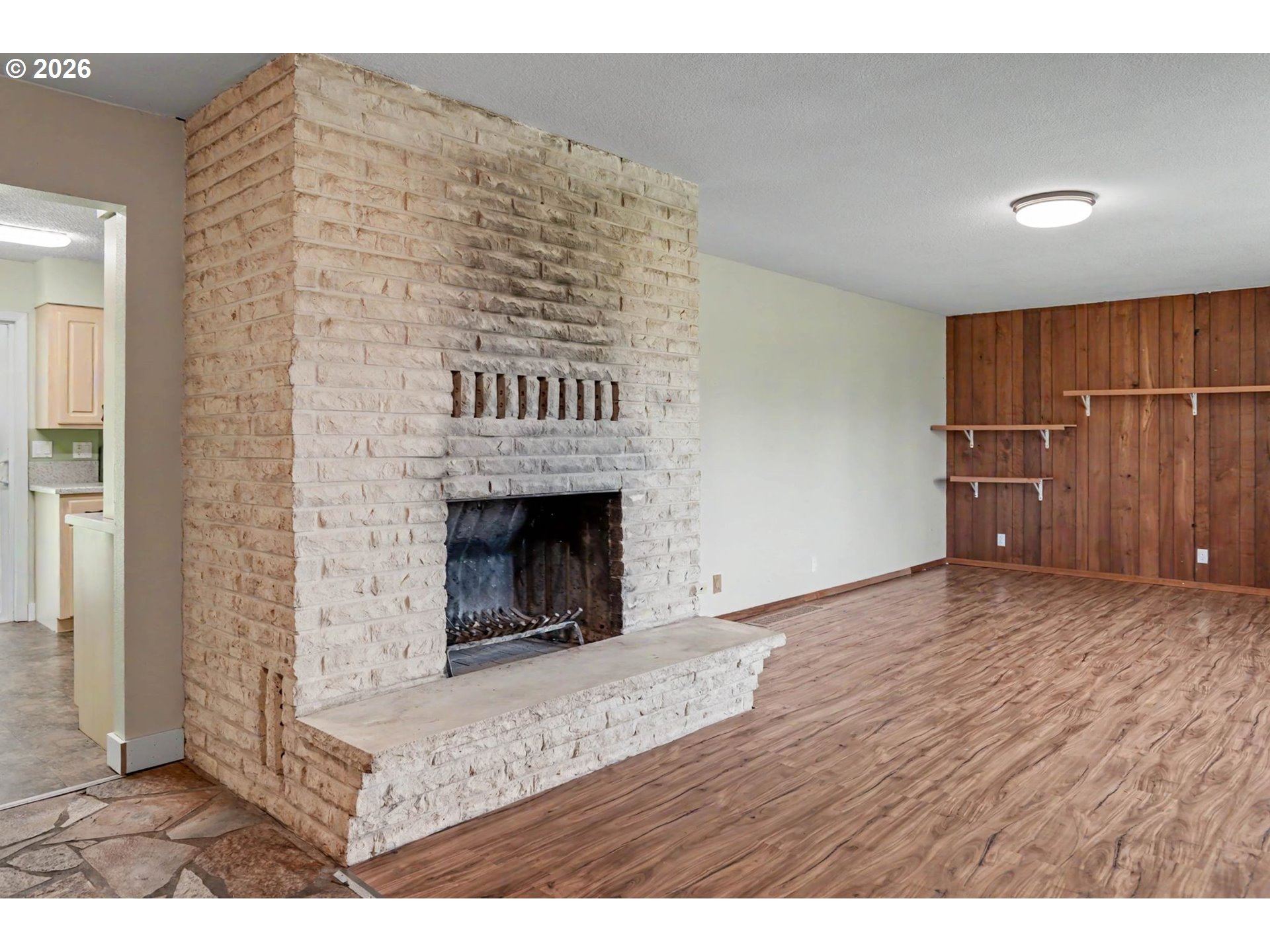 11072 South Bremer Road Canby, OR 97013 - Photo 7 of 44 a view of empty room with wooden floor and fireplace