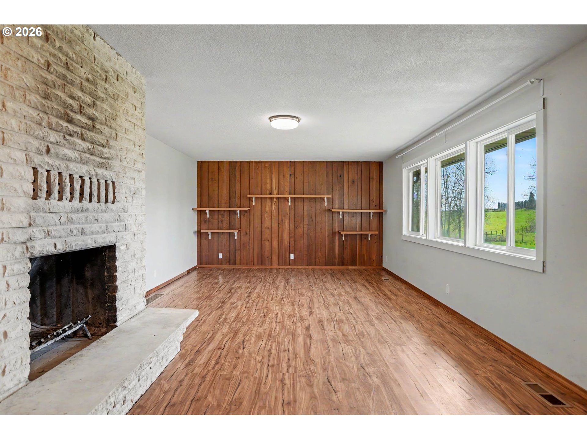 11072 South Bremer Road Canby, OR 97013 - Photo 8 of 44 a view of an empty room with a fireplace and window