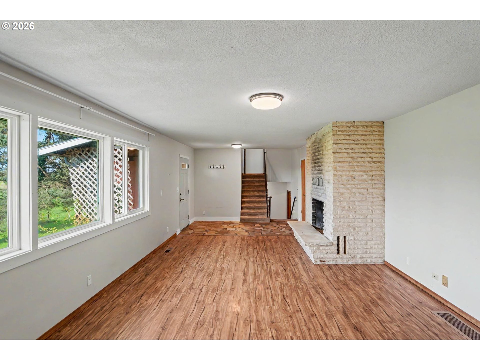 11072 South Bremer Road Canby, OR 97013 - Photo 9 of 44 a view of an empty room with wooden floor and a window
