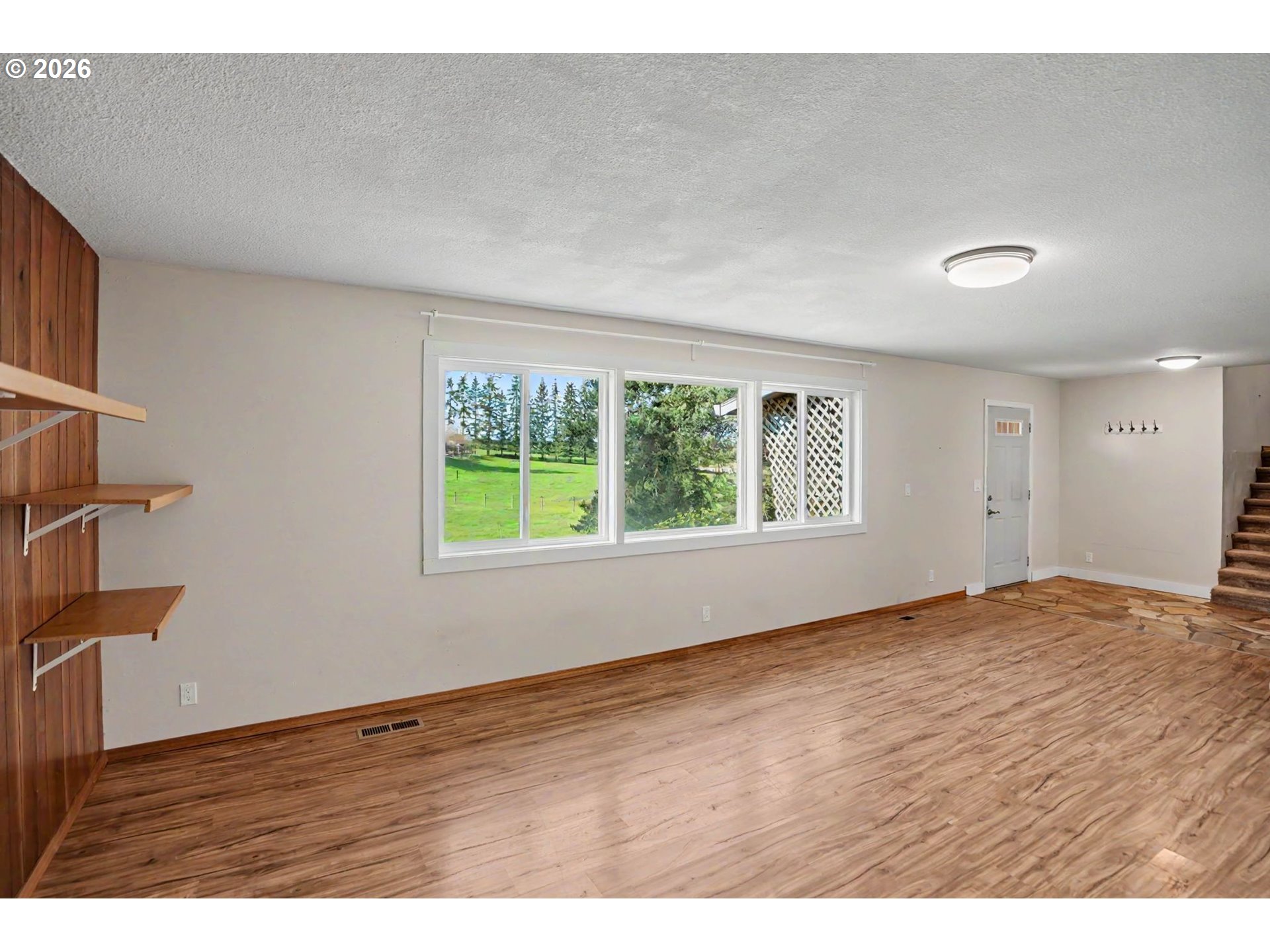 11072 South Bremer Road Canby, OR 97013 - Photo 10 of 44 a view of an empty room with wooden floor and a window
