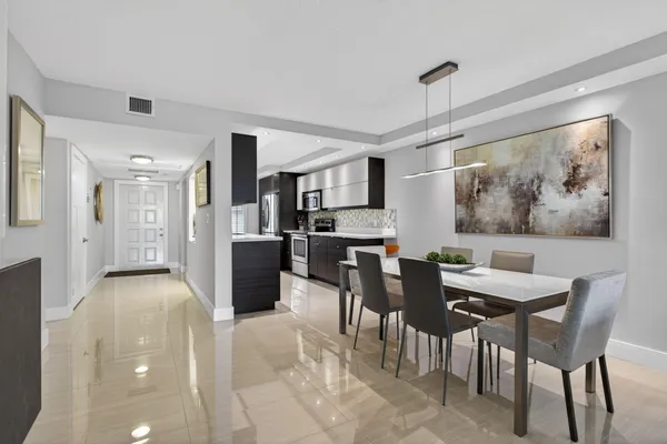 a view of a dining room with furniture and a kitchen