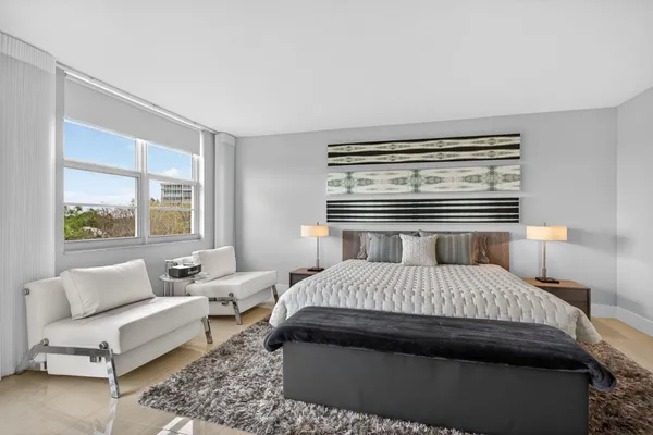 a bedroom with a large bed and a window