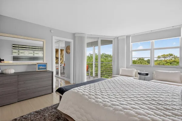 a bedroom with a bed and a lamp with wooden floor