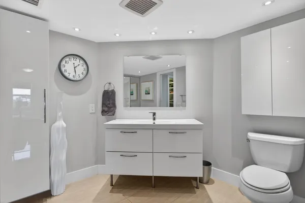 a bathroom with a glass shower door and a mirror