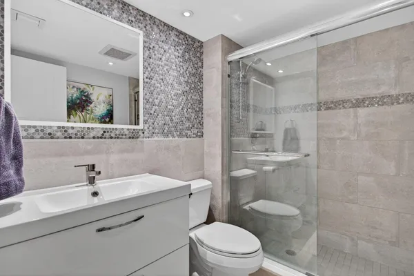 a bathroom with a sink toilet and mirror