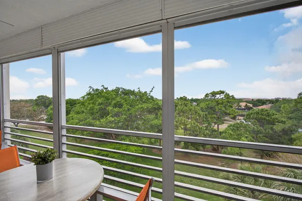 a view of a glass door with a balcony from a window