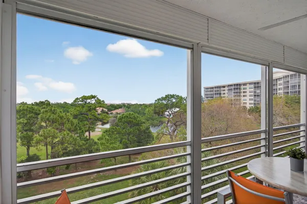 a balcony with table and chairs