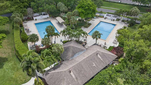 a view of a swimming pool and trees in the background