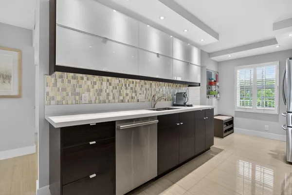 a kitchen with a sink cabinets and window