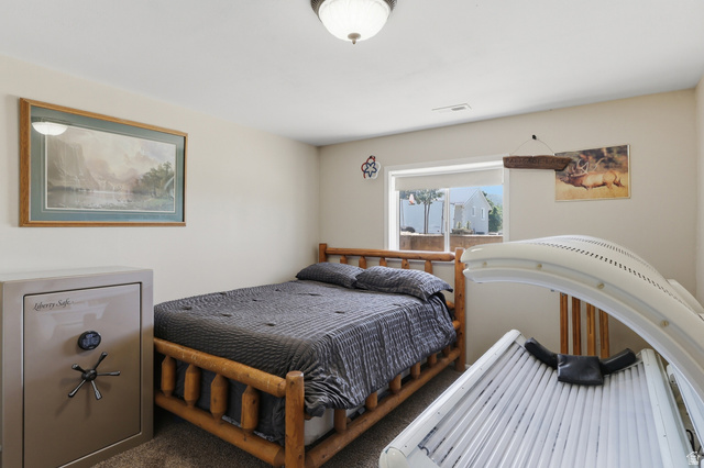 114 North Clark Lane Elk Ridge, UT 84651 - Photo 18 of 26 Carpeted bedroom with a window offering natural light