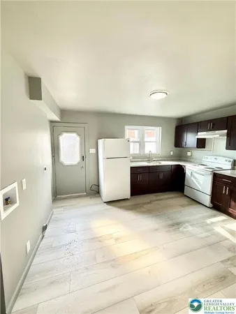 a view of a kitchen with a sink and cabinets