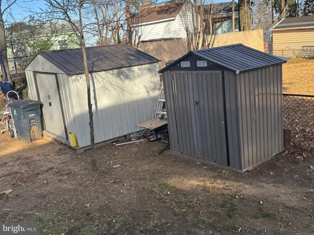 a view of a house with a yard and wooden fence