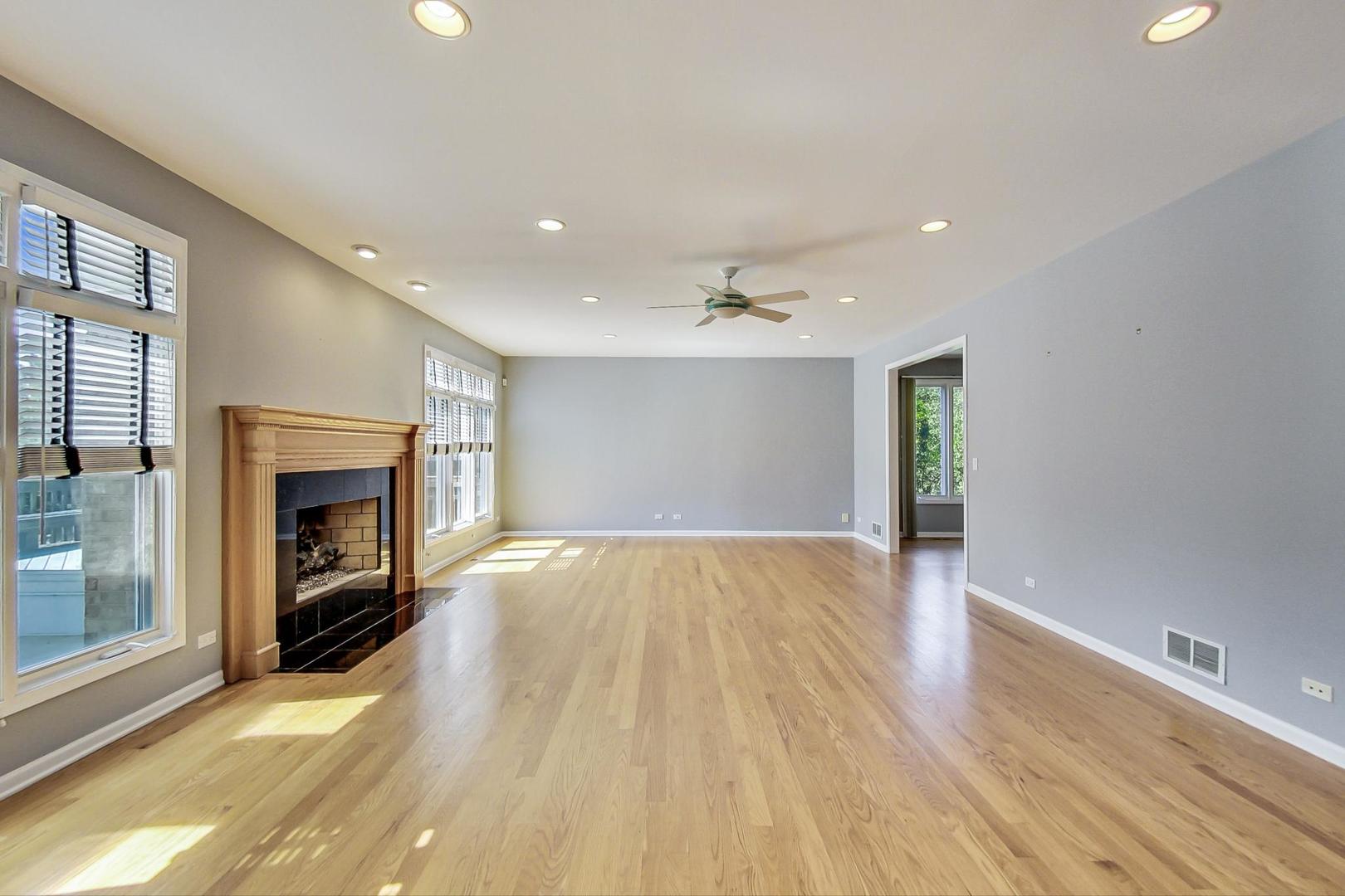 36 Riverside Drive Deerfield, IL 60015 - Photo 14 of 42 a view of an empty room with a fireplace and a window