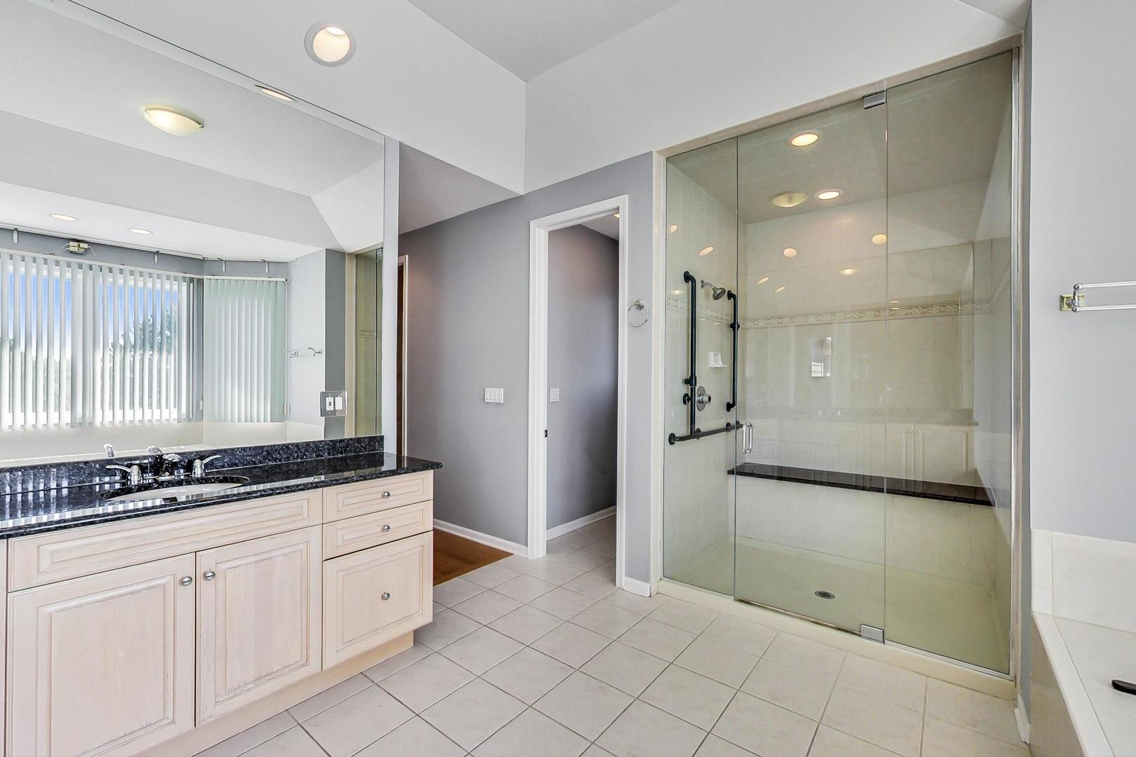 36 Riverside Drive Deerfield, IL 60015 - Photo 26 of 42 a bathroom with a shower a sink and a mirror