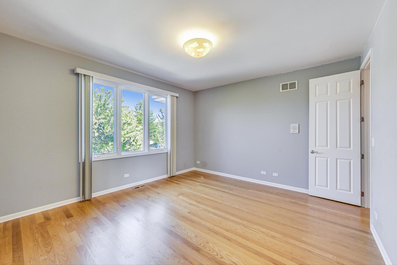 36 Riverside Drive Deerfield, IL 60015 - Photo 29 of 42 a view of an empty room with window and wooden floor