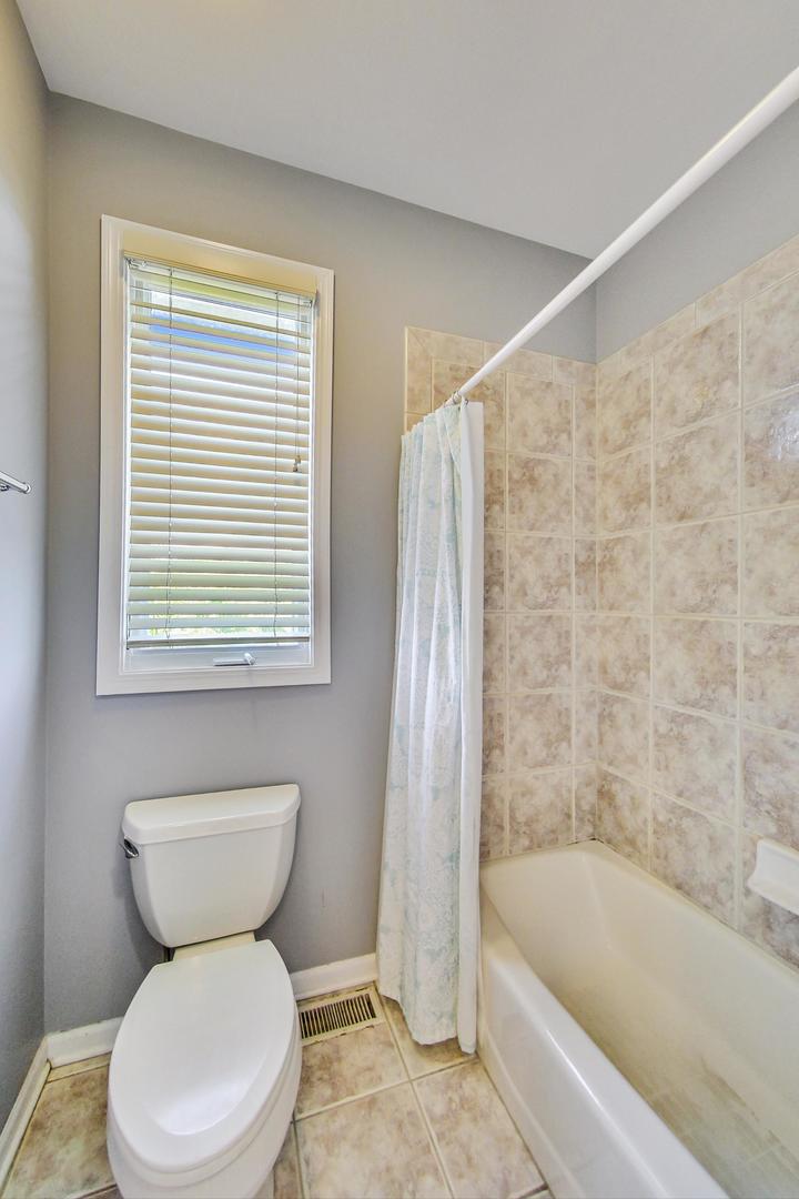 36 Riverside Drive Deerfield, IL 60015 - Photo 30 of 42 a white toilet sitting next to a bath tub and a shower