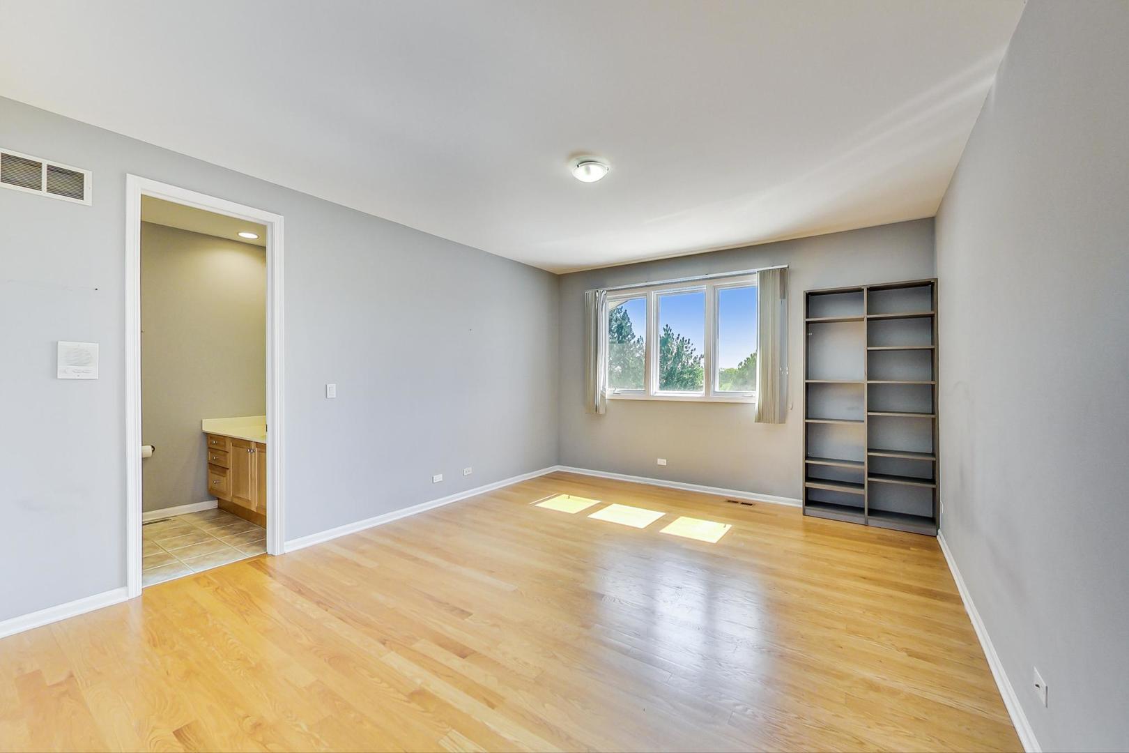 36 Riverside Drive Deerfield, IL 60015 - Photo 32 of 42 a view of an empty room with a window and wooden floor