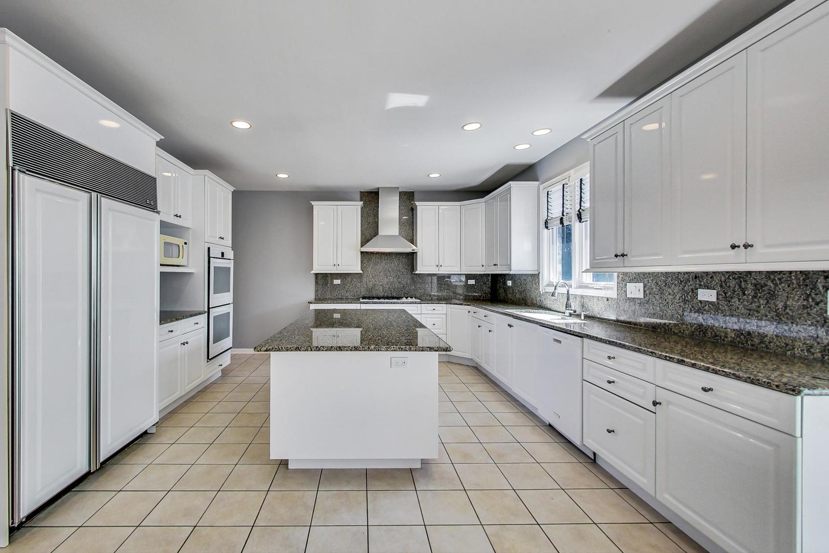 36 Riverside Drive Deerfield, IL 60015 - Photo 8 of 42 a large kitchen with stainless steel appliances lots of white cabinets
