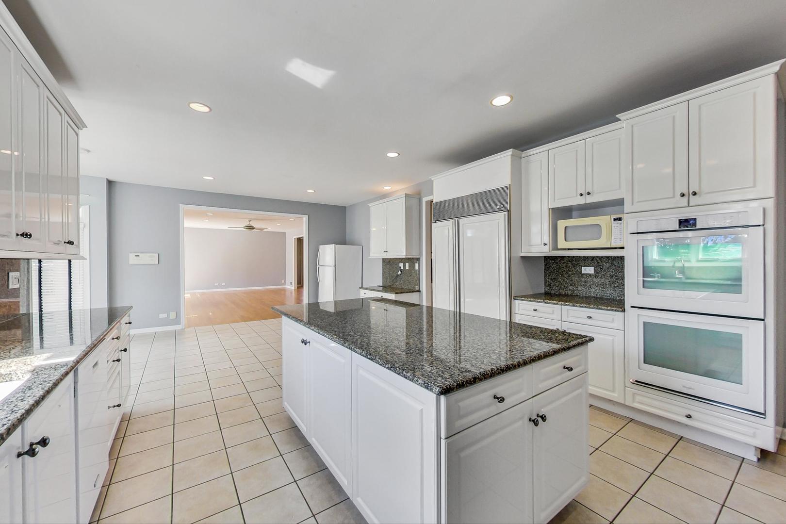 36 Riverside Drive Deerfield, IL 60015 - Photo 10 of 42 a kitchen with stainless steel appliances granite countertop a sink and a stove