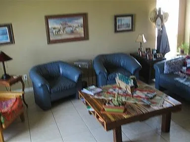 a living room with furniture and a lamp