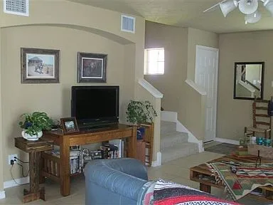 a living room with furniture and a flat screen tv