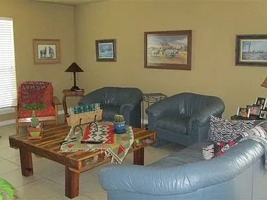 a living room with furniture and a lamp