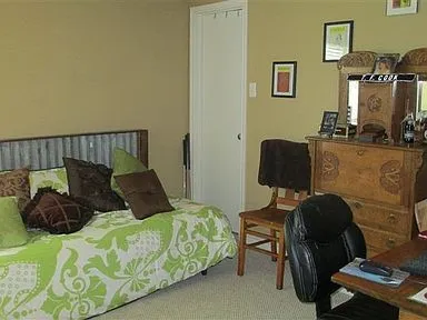 a bedroom with a bed and a chair