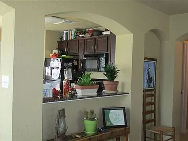 a view of living room with furniture and potted plants