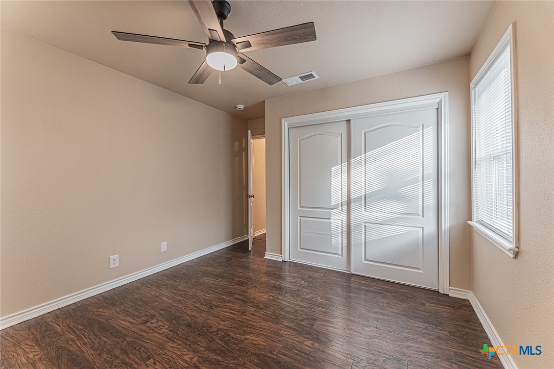 1102 End O Trail Harker Heights, TX 76548 - Photo 16 of 38 an empty room with wooden floor fan and windows