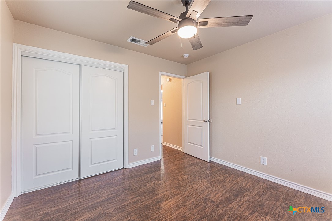 1102 End O Trail Harker Heights, TX 76548 - Photo 19 of 38 an empty room with wooden floor fan and windows