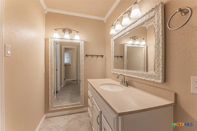 a bathroom with a sink and a mirror