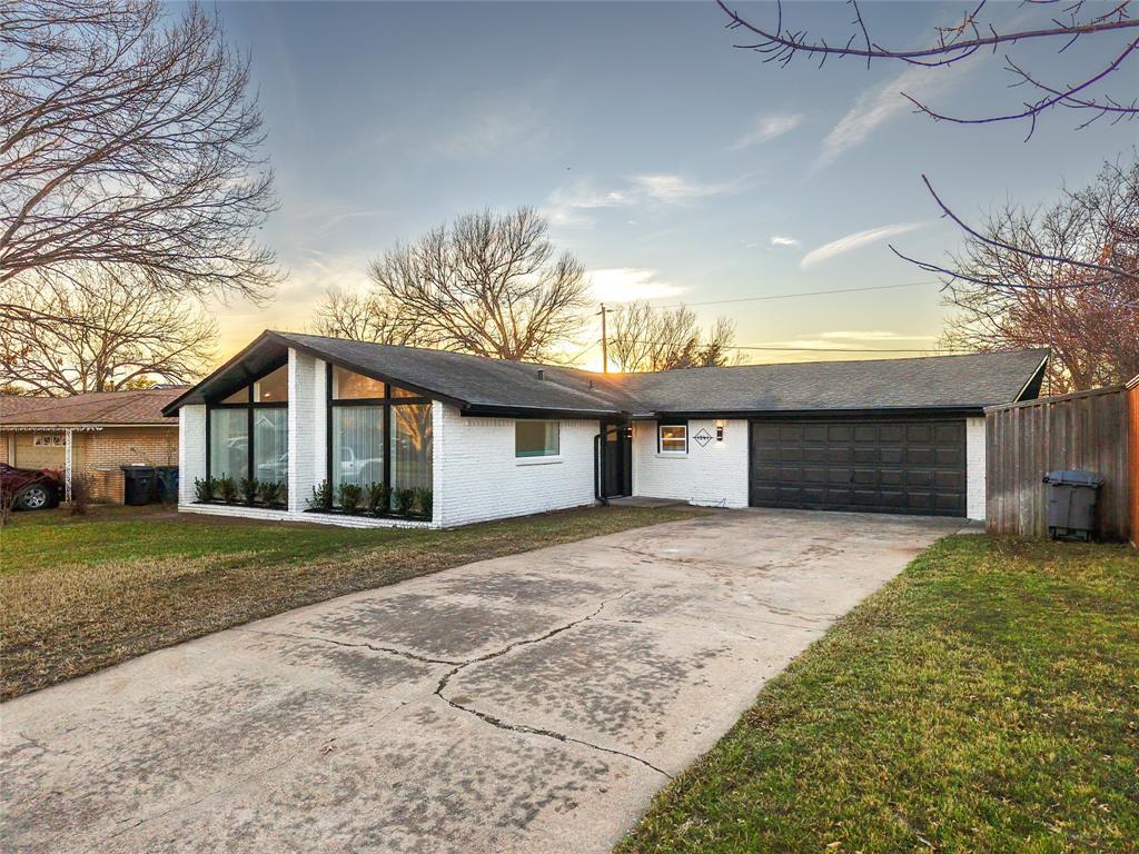 1241 Stevens Ridge Drive Dallas, TX 75211 - Photo 18 of 18 a front view of a house with a yard and garage