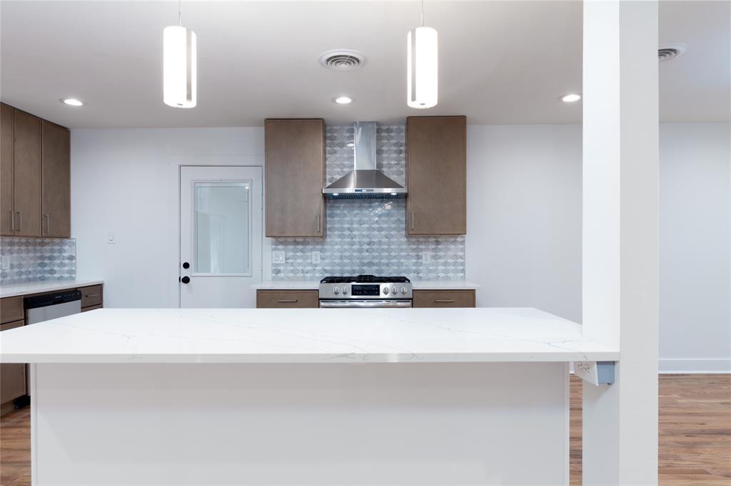 1241 Stevens Ridge Drive Dallas, TX 75211 - Photo 5 of 18 a kitchen with a sink a stove and cabinets