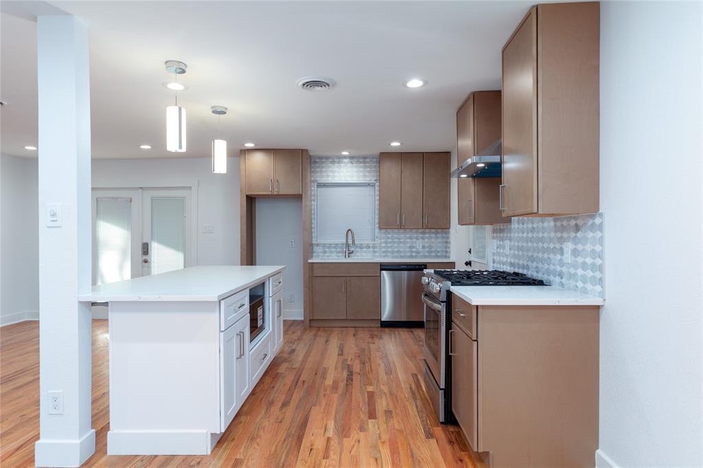 1241 Stevens Ridge Drive Dallas, TX 75211 - Photo 7 of 18 a kitchen with stainless steel appliances granite countertop a sink stove and refrigerator