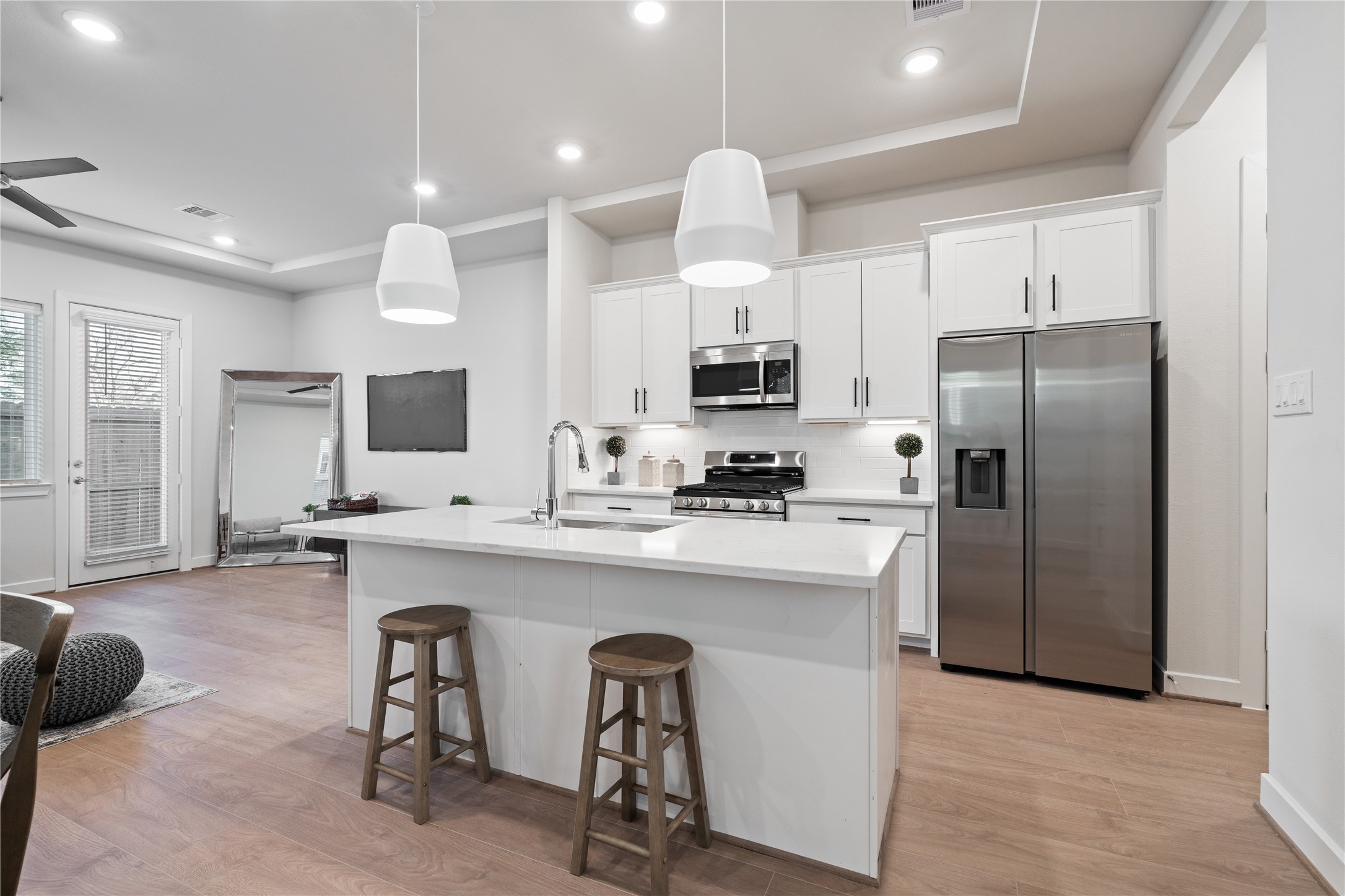 6451 Rena Street Houston, TX 77092 - Photo 6 of 33 A central island with seating anchors the kitchen and supports both quick mornings and casual hosting.