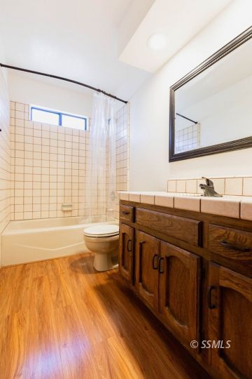 321 South Locust Street Ridgecrest, CA 93555 - Photo 20 of 30 a bathroom with a sink a large mirror and a bathtub