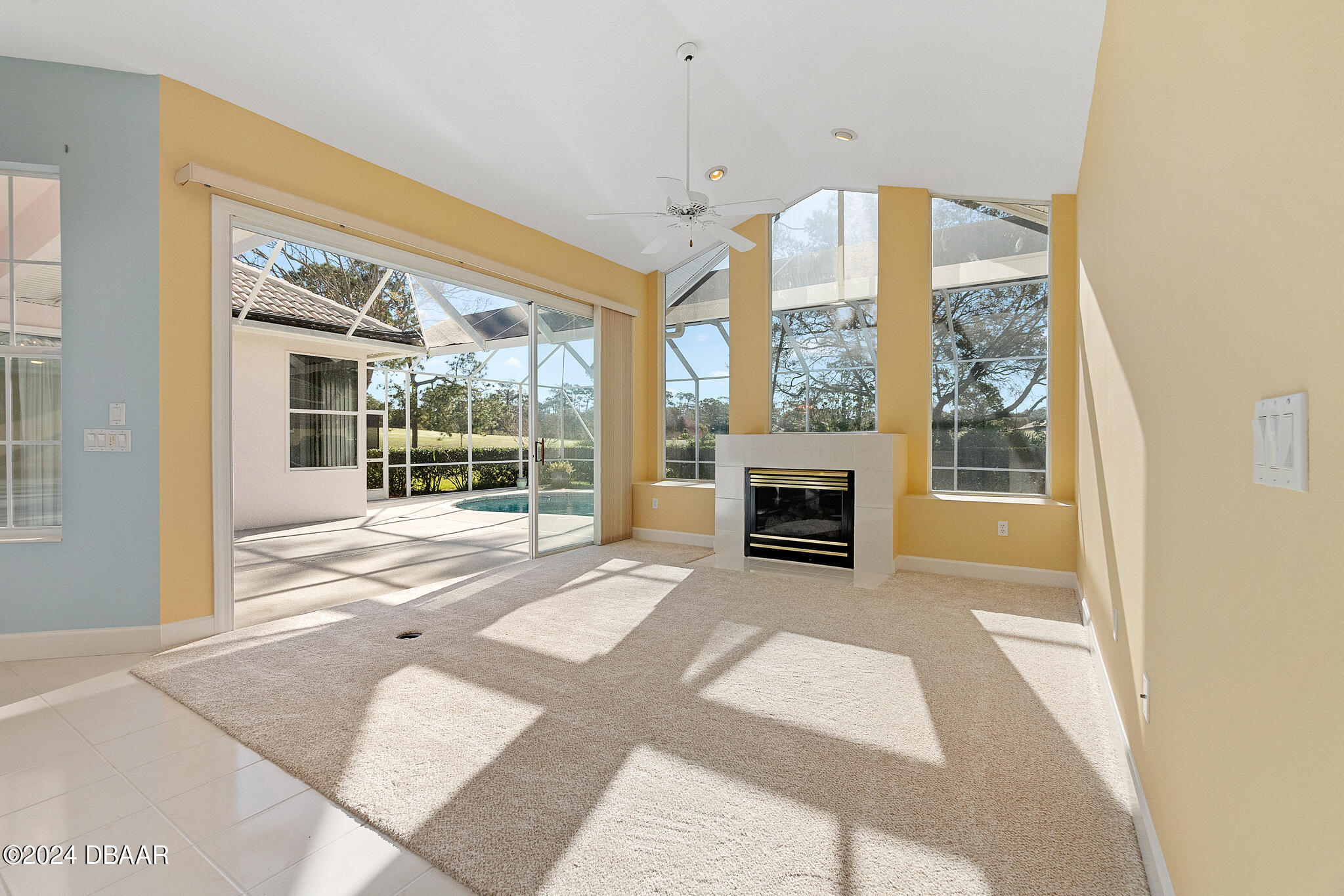710 Dolphin Head Lane Ormond Beach, FL 32174 - Photo 13 of 42 a view of an empty room with a fireplace and a window