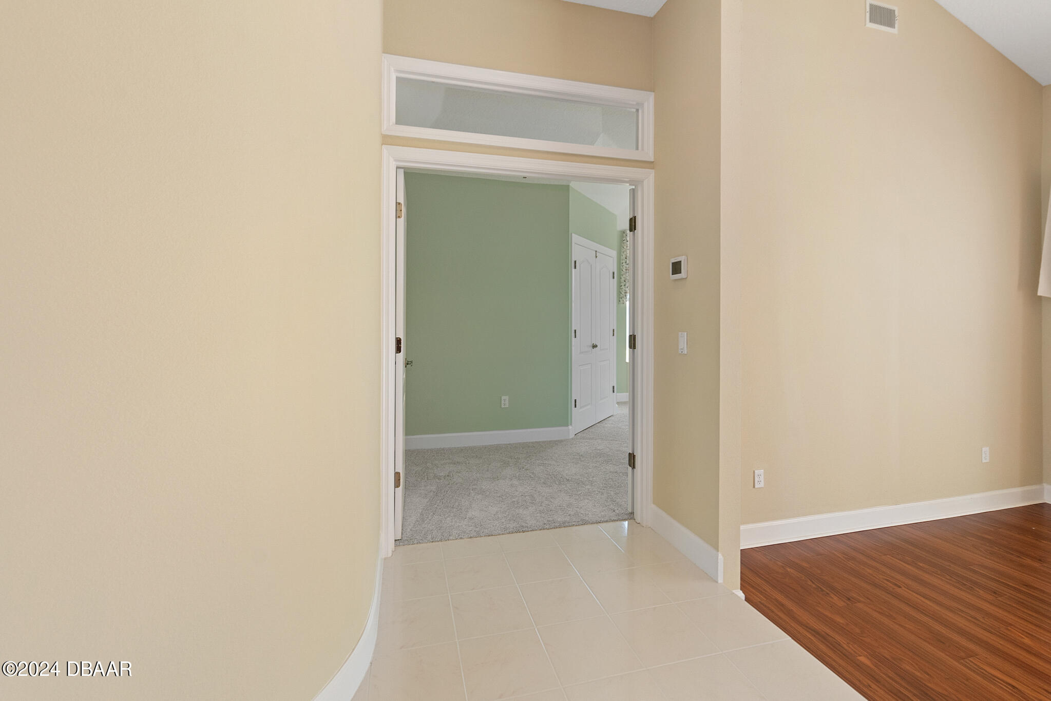 710 Dolphin Head Lane Ormond Beach, FL 32174 - Photo 14 of 42 an empty room with wooden floor and a hallway