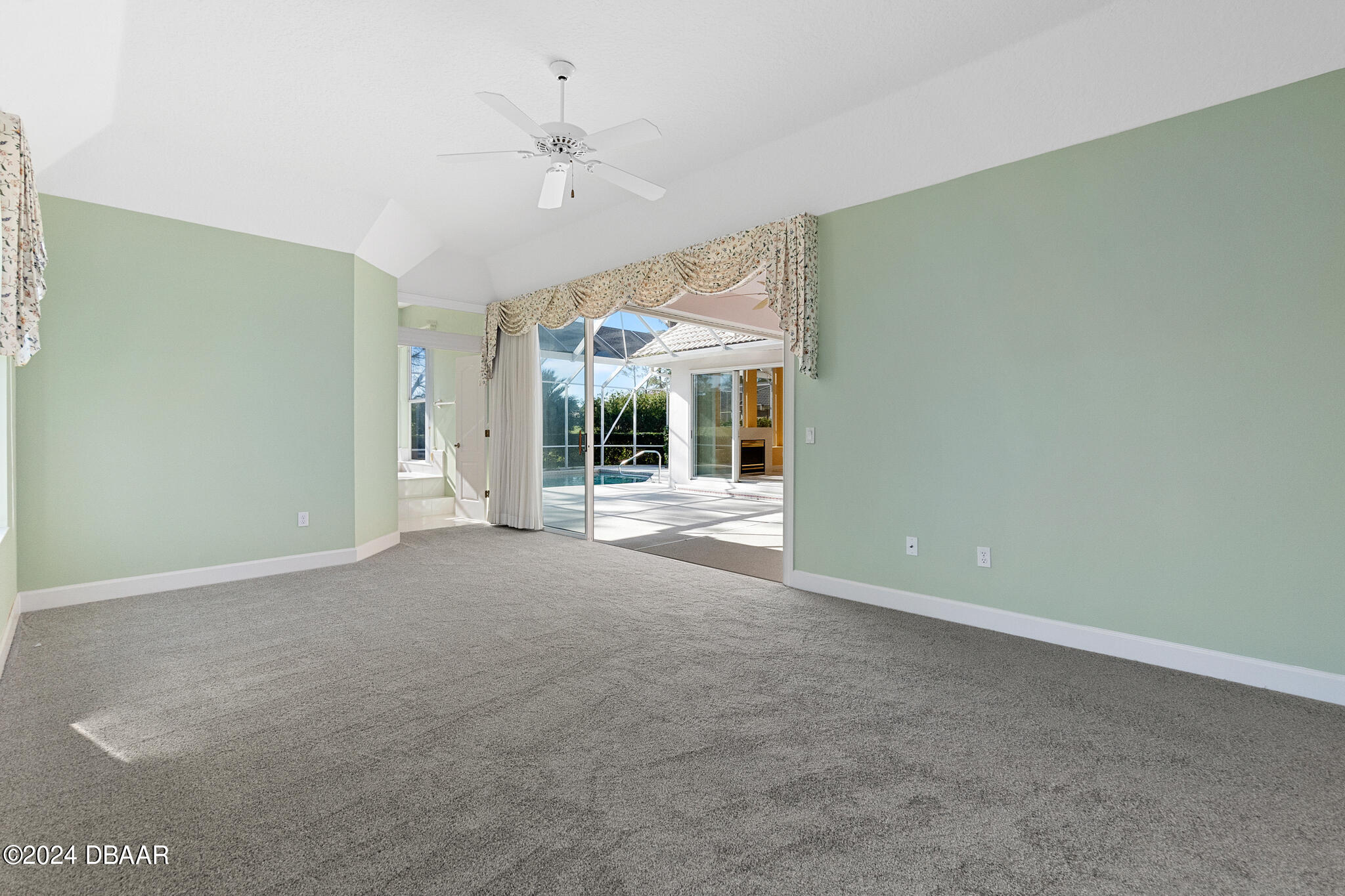 710 Dolphin Head Lane Ormond Beach, FL 32174 - Photo 18 of 42 en empty room with windows and ceiling fan