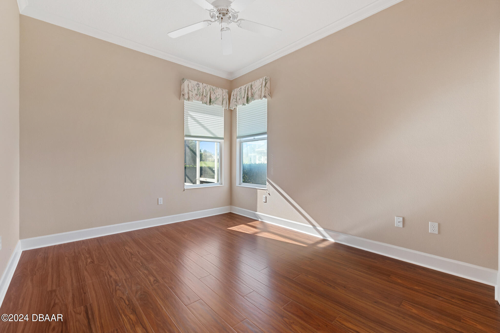 710 Dolphin Head Lane Ormond Beach, FL 32174 - Photo 21 of 42 an empty room with wooden floor fan and windows