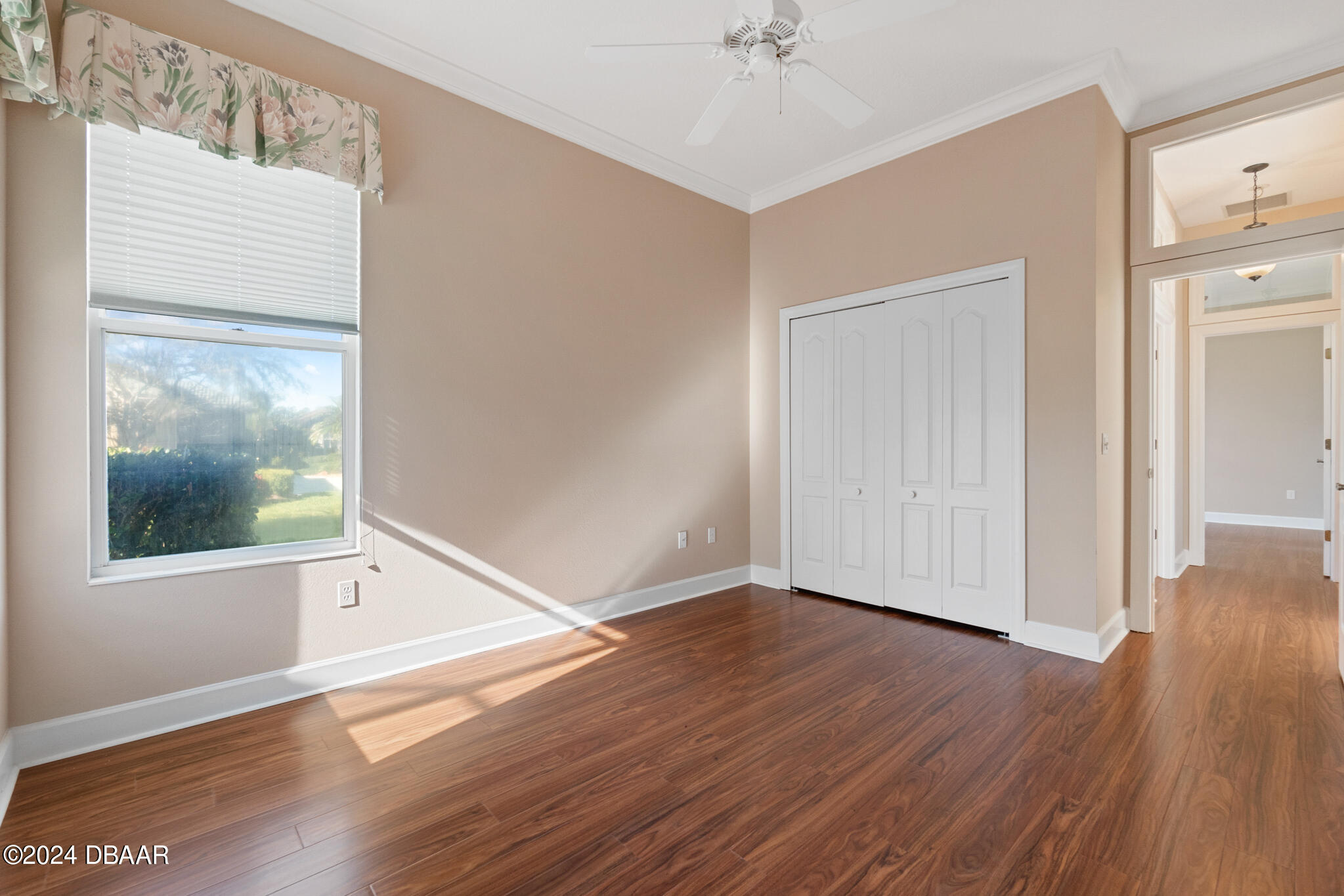 710 Dolphin Head Lane Ormond Beach, FL 32174 - Photo 22 of 42 a view of an empty room with wooden floor and a window