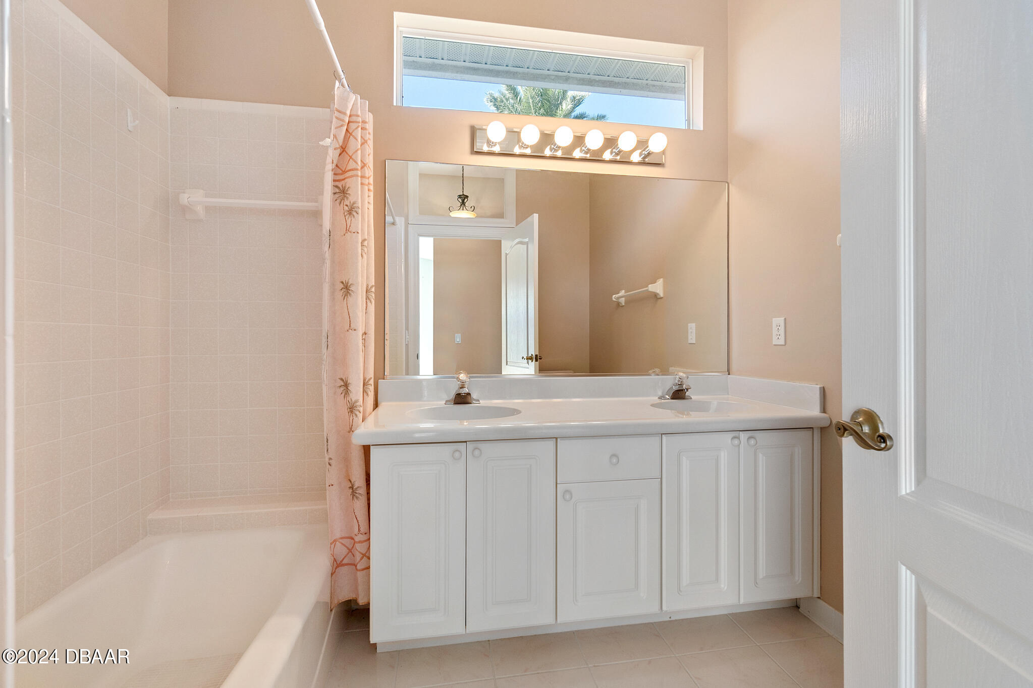 710 Dolphin Head Lane Ormond Beach, FL 32174 - Photo 23 of 42 a bathroom with a double vanity sink and a bathtub