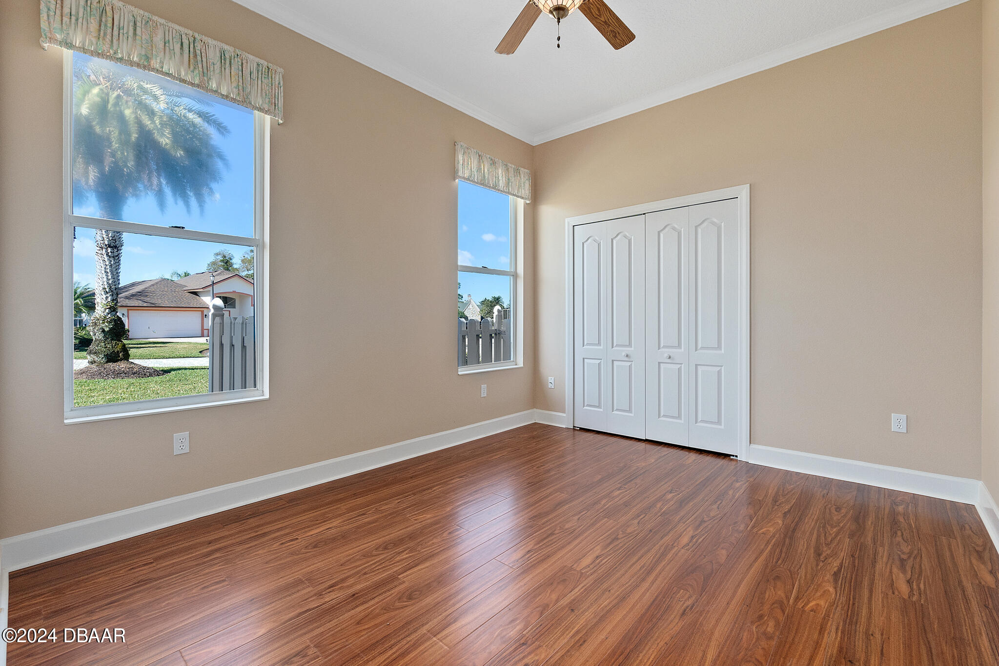 710 Dolphin Head Lane Ormond Beach, FL 32174 - Photo 24 of 42 a view of an empty room with window and wooden floor