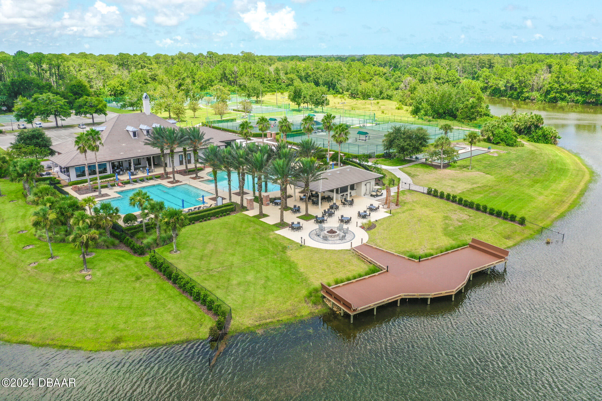 710 Dolphin Head Lane Ormond Beach, FL 32174 - Photo 37 of 42 a view of a swimming pool with lawn chairs and a big yard