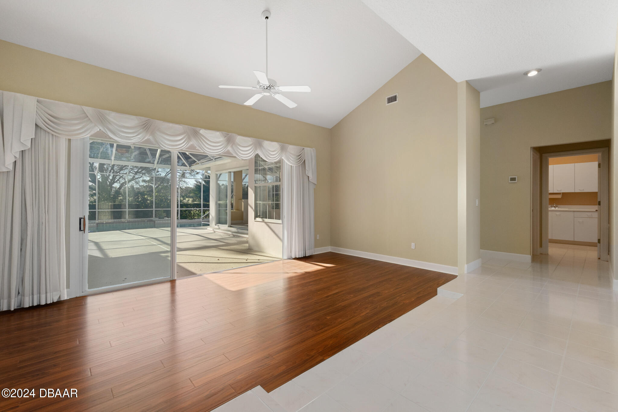 710 Dolphin Head Lane Ormond Beach, FL 32174 - Photo 4 of 42 a view of an empty room with wooden floor and a window
