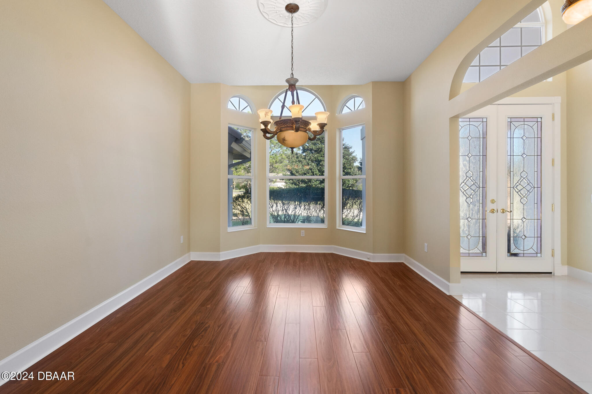 710 Dolphin Head Lane Ormond Beach, FL 32174 - Photo 5 of 42 a view of a room with wooden floor chandelier and windows
