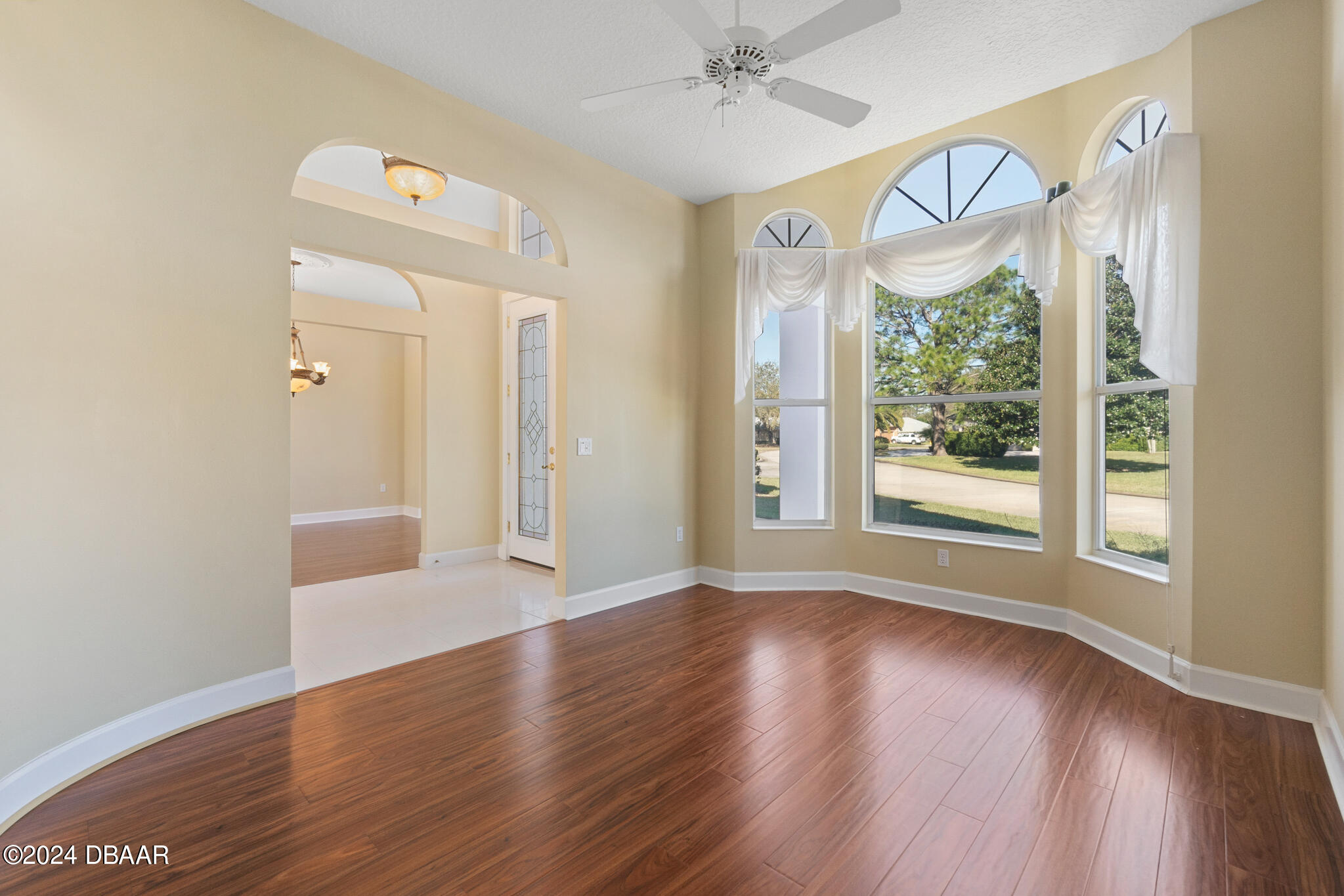 710 Dolphin Head Lane Ormond Beach, FL 32174 - Photo 7 of 42 a view of an empty room with wooden floor and a window